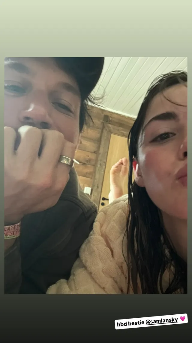 Kiernan Shipka taking a selfie beside a friend indoors.