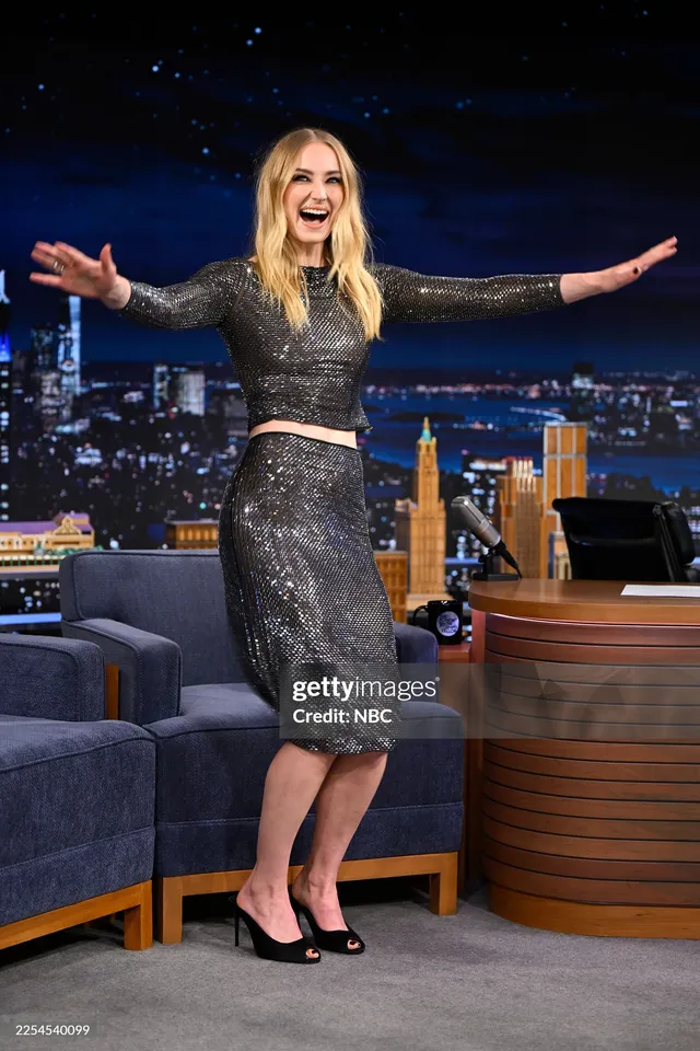 Sophie Turner a sparkling black dress during a late-night interview.