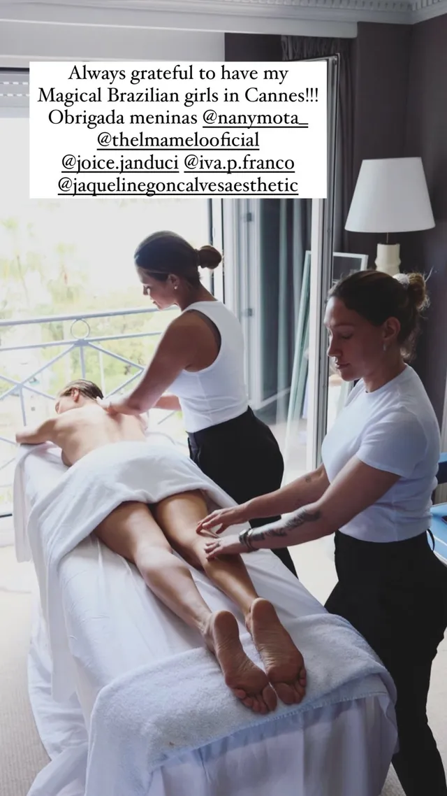 Alessandra Ambrosio relaxing on a treatment bed with bare soles visible.