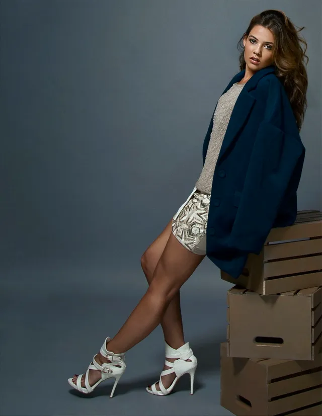 Danielle Campbell posing for a studio portrait in a blue jacket.