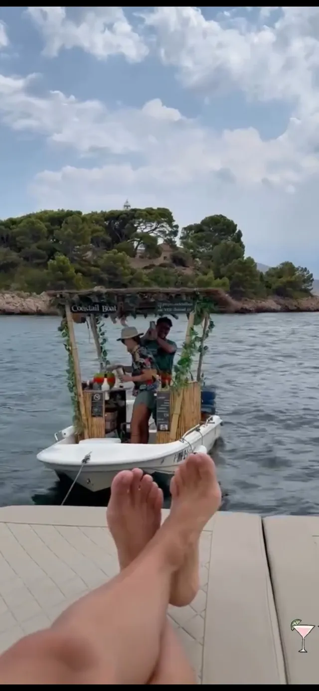 Eva Longoria relaxing on a boat with her legs crossed.
