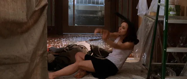 Rachel McAdams reclining barefoot on a rug in a screen image.