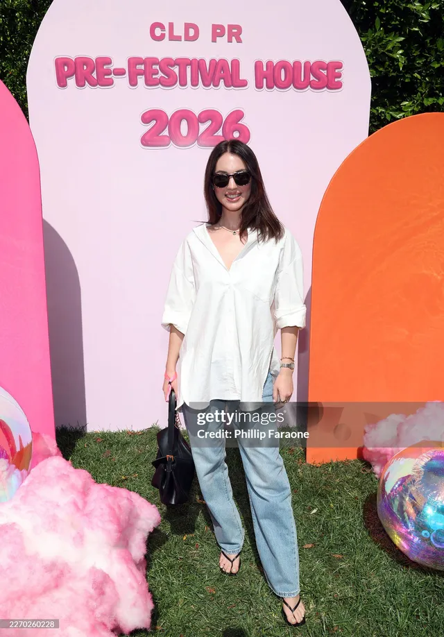 Adelaide Kane posing at an outdoor event in jeans and flip-flops.