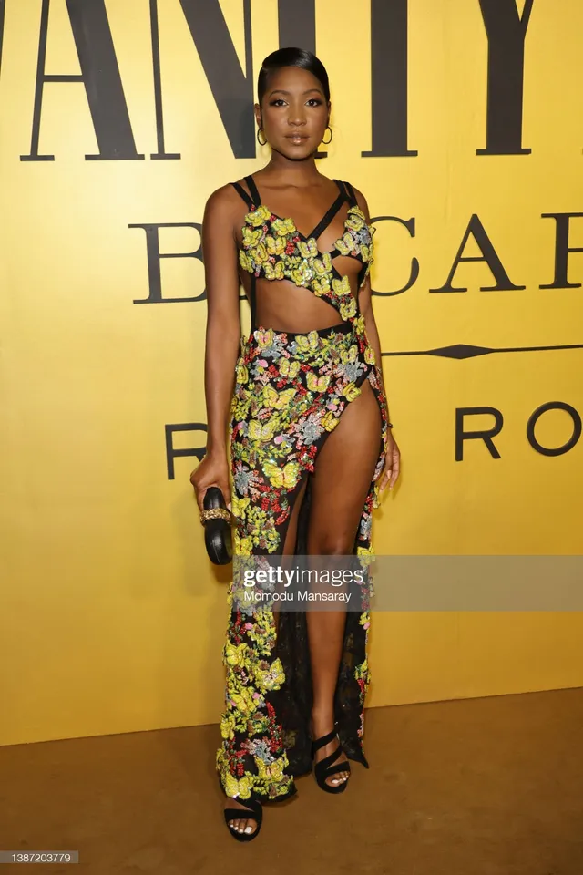 Carlacia Grant wearing a patterned cutout dress and black heels at an event.