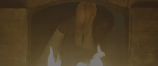 Margaret Qualley a dimly lit screen detail of raised soles.