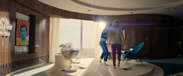 Vanessa Kirby a standing screen scene in a bright room.