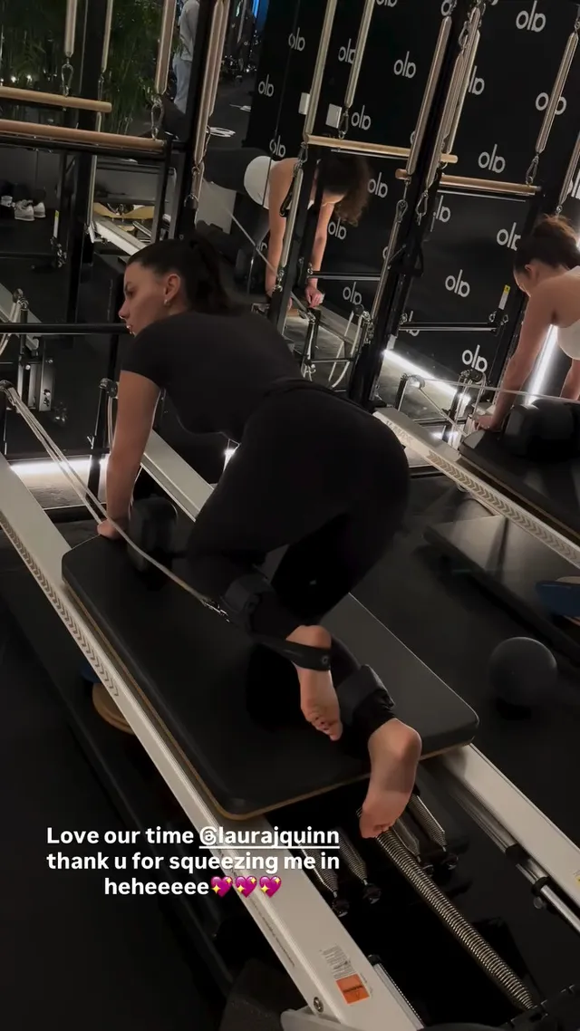 Dafne Keen exercising barefoot on a Pilates reformer.