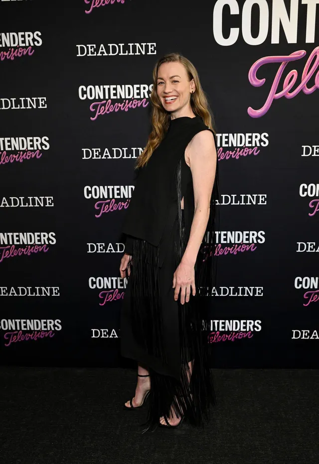 Yvonne Strahovski posing at a television event in a long black dress.