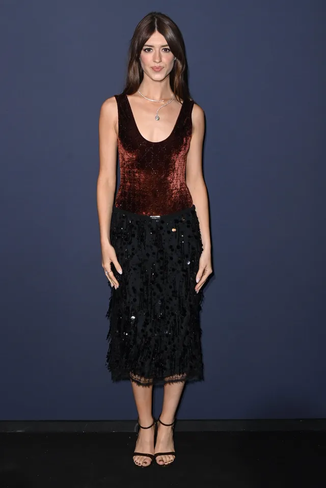 Daisy Edgar-Jones posing at an event in a black lace skirt.
