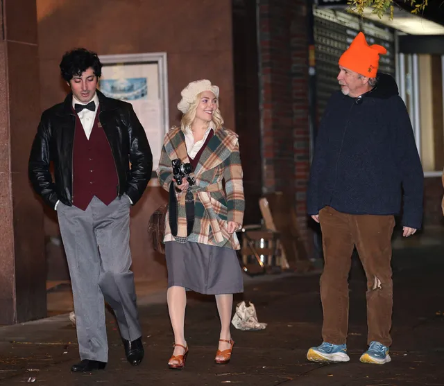 AnnaSophia Robb standing with cast members during a street production.