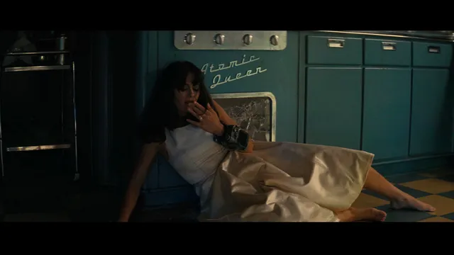 Ella Purnell sitting on a floor in a dramatic screen scene.