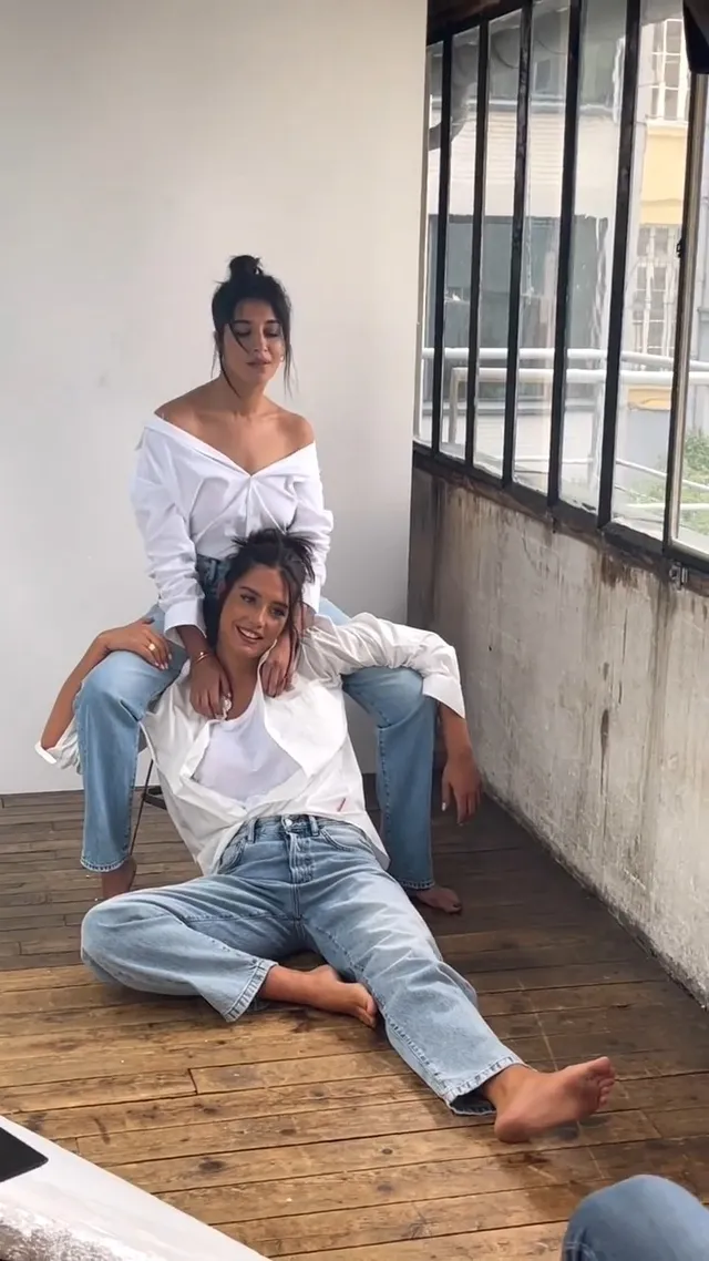 Adèle Exarchopoulos sitting on a floor with another woman nearby.