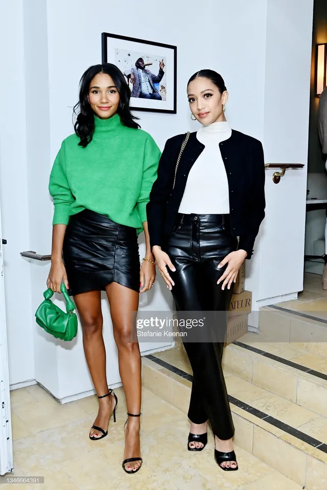 Samantha Logan posing beside a guest in black trousers and open-toe heels.
