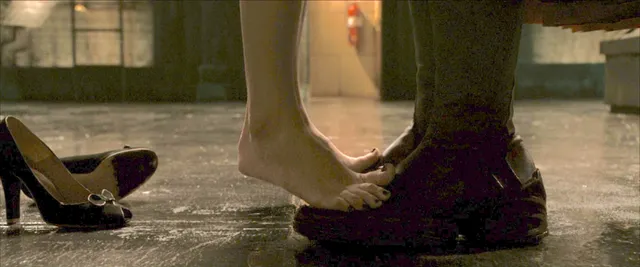 Kate Bosworth standing beside black pumps in a screen scene.