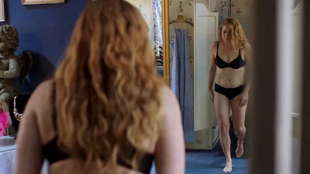 Amy Adams standing beside a mirror during a screen scene.