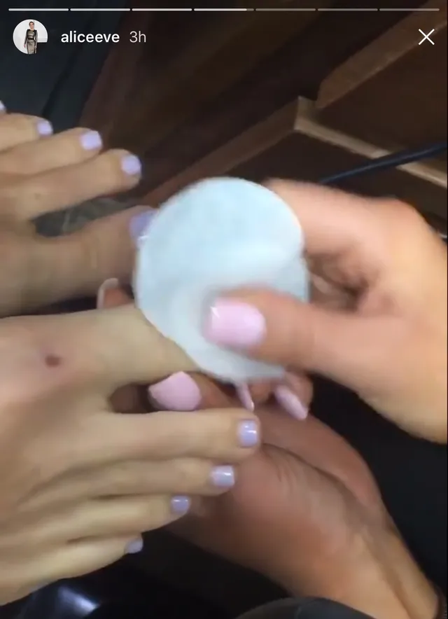 Alice Eve having a pedicure while seated.