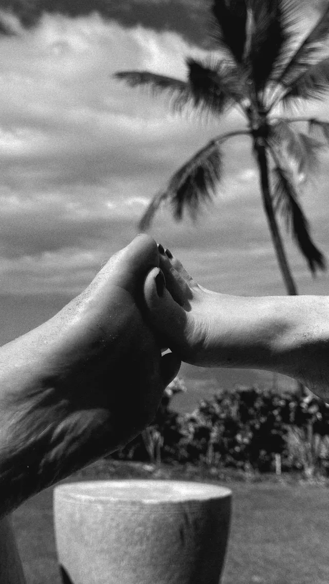 Phoebe Dynevor showing bare soles outdoors in a black and white photograph.