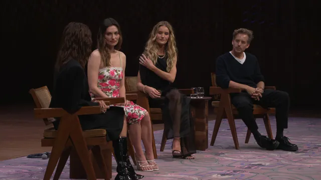 Phoebe Tonkin sitting with fellow guests during a panel discussion.