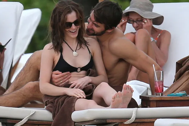 Emma Watson: reclining barefoot on an outdoor lounger with friends.
