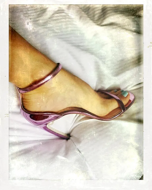 Alice Eve wearing metallic purple sandals.