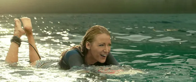 Blake Lively floating in water with bare soles raised in a screen scene.