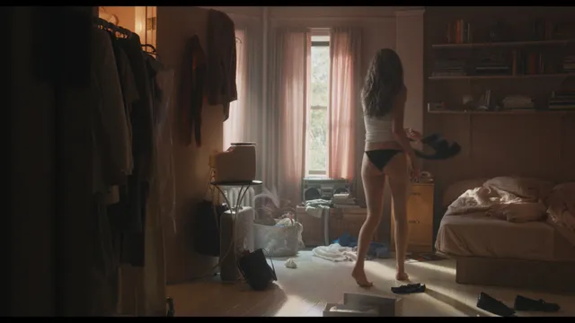 Sarah Pidgeon standing barefoot in a room in a screen capture.