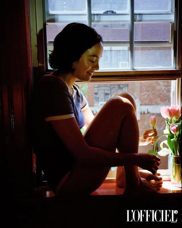 Chase Sui Wonders sitting barefoot on a windowsill.