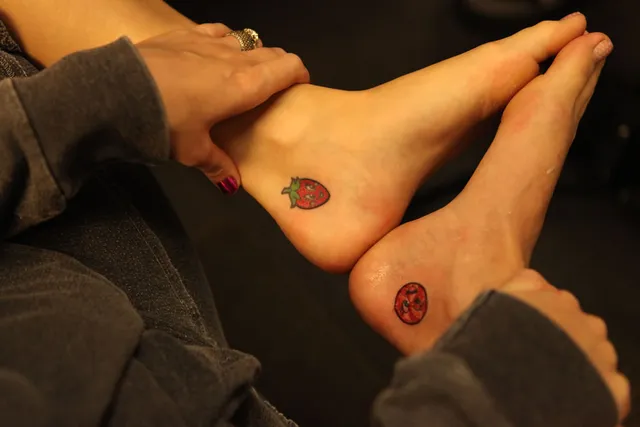 Katy Perry resting bare feet during a close-up indoor photograph.