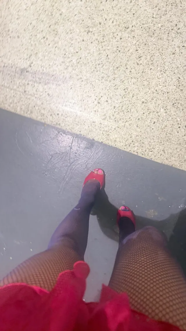 Addison Rae a downward view of fishnet hosiery and ribbon-trimmed footwear.