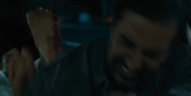Zoe Saldaña appearing beside a man in a dramatic screen scene.