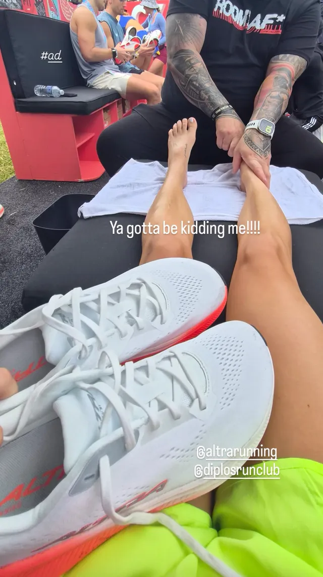 Claire Holt a casual view of bare feet at a sporting event.