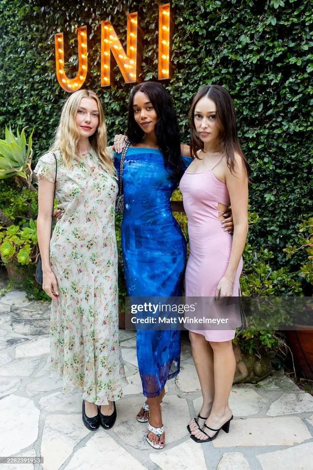 Alycia Debnam-Carey posing with companions at an outdoor event.