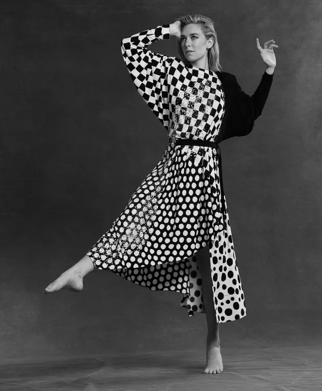 Vanessa Kirby a monochrome studio portrait in a patterned outfit.