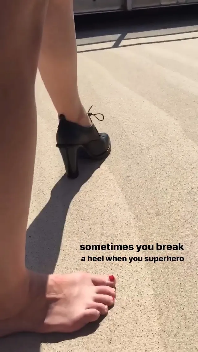 Melissa Benoist a casual detail of a bare foot beside a heeled boot.