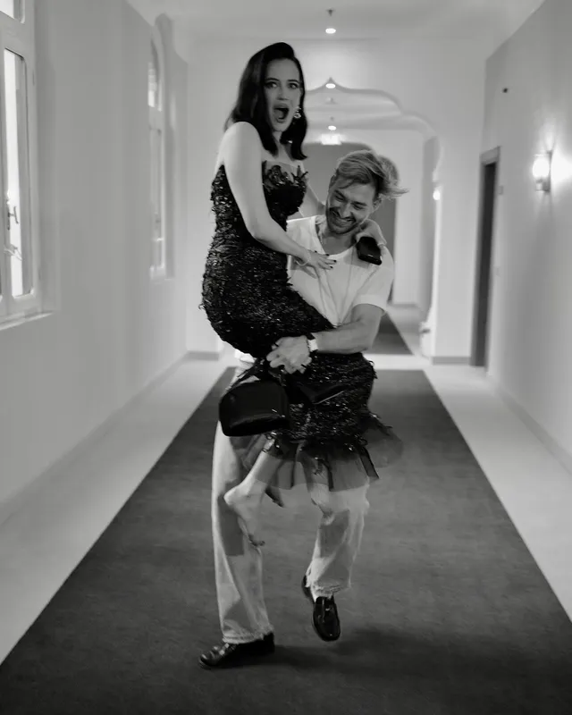 Eva Green a monochrome scene being carried by a colleague.