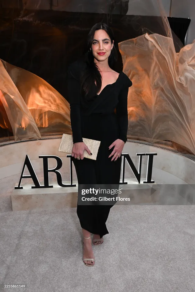 María Gabriela de Faría wearing a black dress and pale heels at an event.
