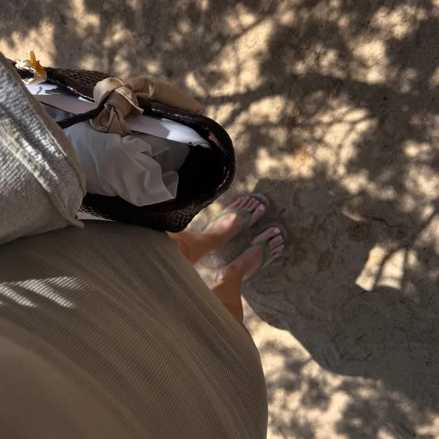 Alycia Debnam-Carey a casual view of flip-flops on a shaded path.