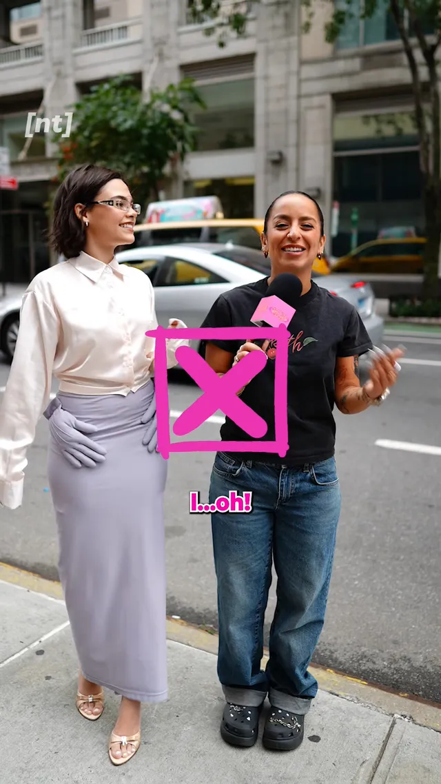 Ariana Greenblatt walking beside another person in a pale outfit and metallic heels.