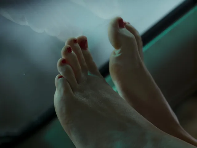 Jennifer Lawrence showing a bare foot in a close-up screen scene.