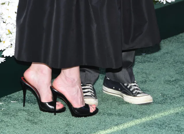 Kirsten Dunst wearing black high-heeled sandals at an event.