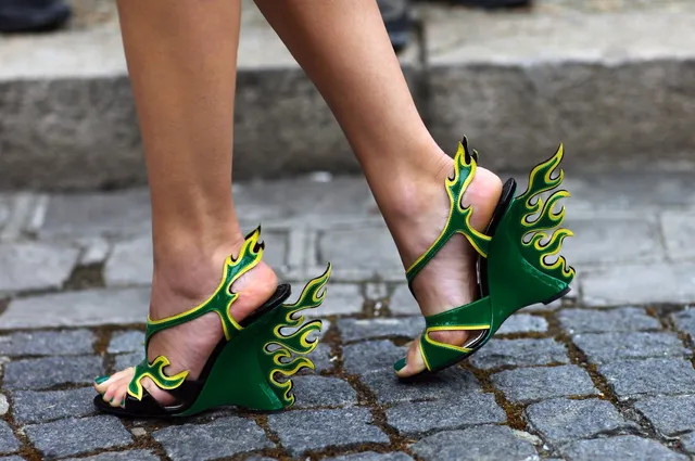 Léa Seydoux wearing sculptural green flame sandals.