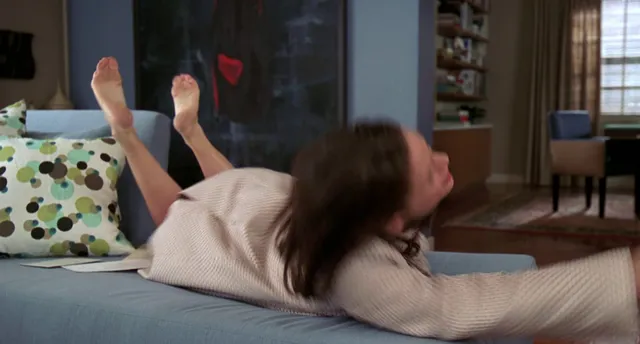 Jennifer Garner lying on a sofa during a screen scene.