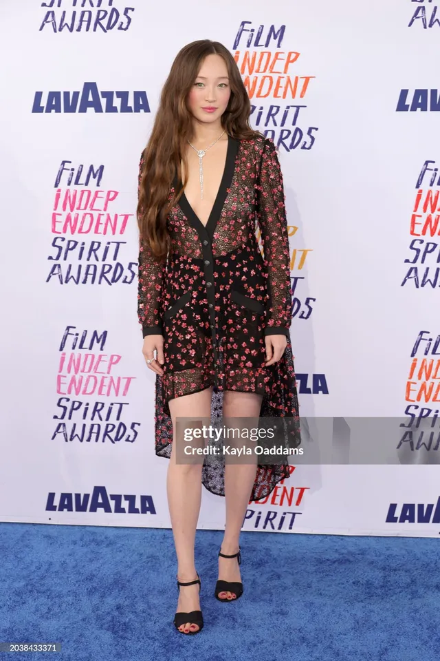 Havana Rose Liu wearing a floral dress and black heels at an awards event.
