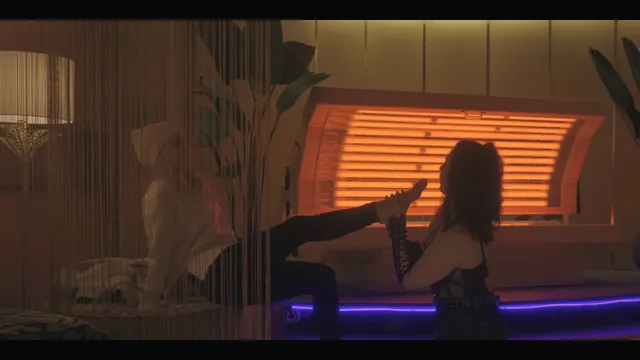 Kate Beckinsale sitting indoors with a bare foot extended in a screen image.