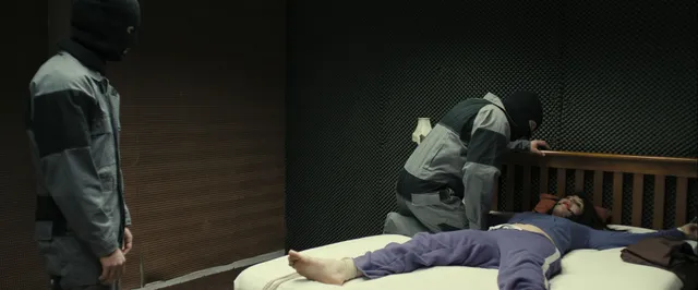 Gemma Arterton lying beside other performers in a screen scene.