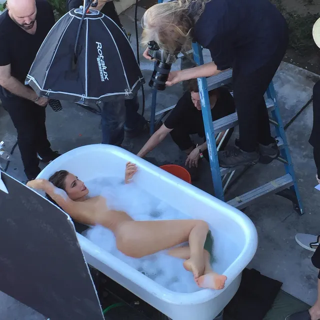 Sofía Vergara reclining in a bathtub during a photo shoot with her bare feet visible.