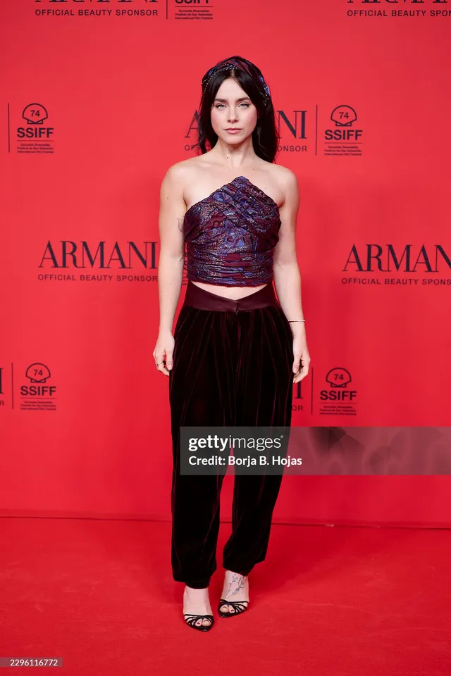 Clara Galle wearing a dark skirt outfit and heels at an Armani event.