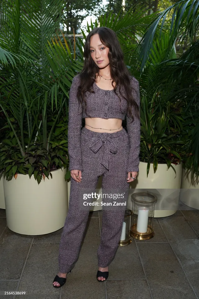 Havana Rose Liu posing in a patterned trouser outfit and heels.