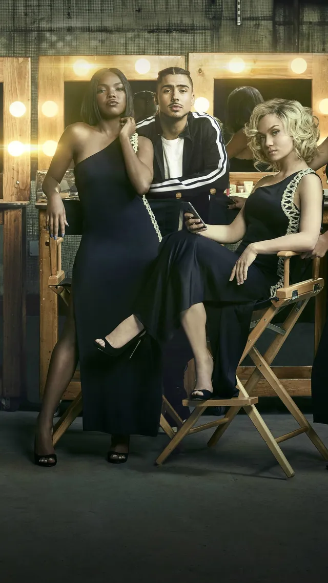 Ryan Destiny posing with fellow performers in a dark outfit and heels.