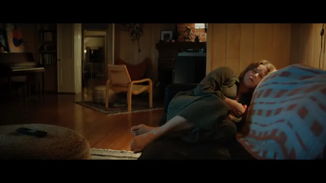 Amy Adams reclining indoors during a screen scene.